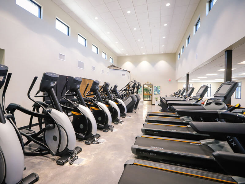 rows of treadmills and other workout equipment inside Core Athletic Club