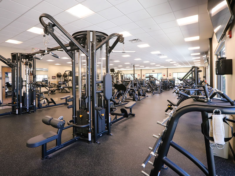 large room of various workout equipment