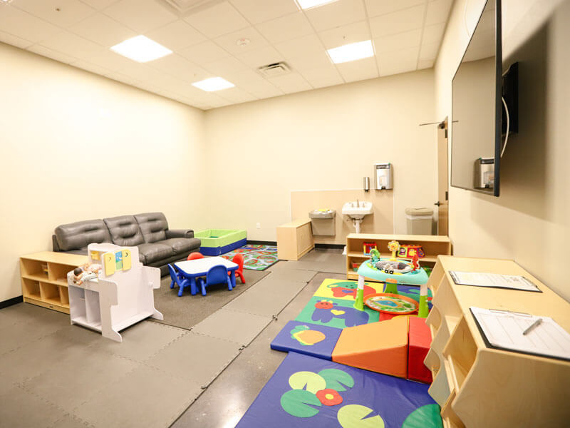 child care room with play mats and toys